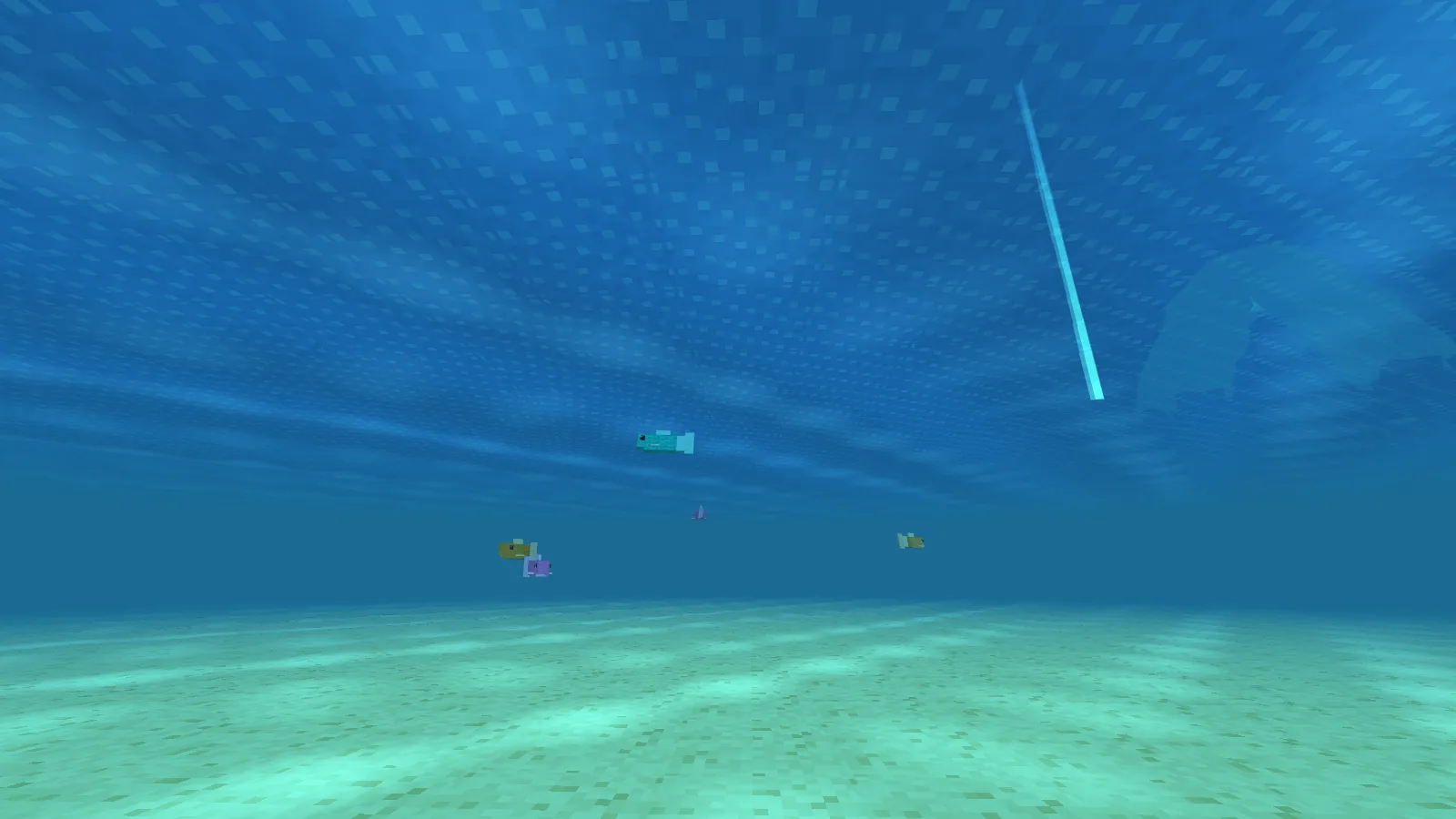 Under the sea, with colourful blocky fish swimming above a sandy seabed